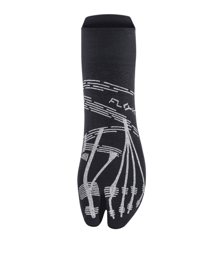 Front view of black Floky KINETICA Silver Glitter pilates grip sock showing silver anatomical toe-line grip pattern, FLOKY logo in silver at mid-foot, split-toe design at base, product shot on white background