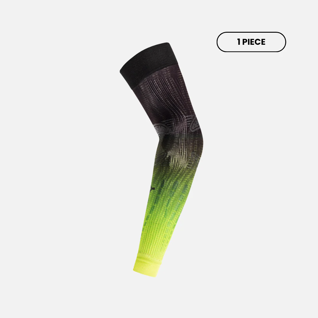 Side view of Floky No-Strain arm sleeve in Articence colourway showing charcoal black to neon yellow-green gradient ombre with geometric grid anatomical zone mapping, single piece bent at elbow, product shot on light grey background