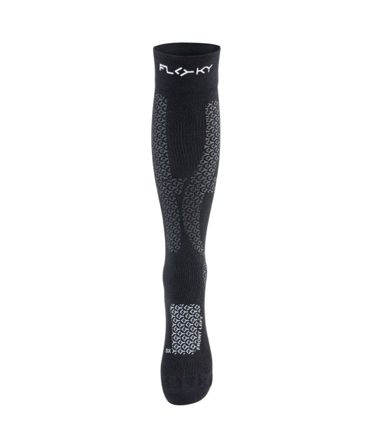 Front view of black Floky Jumper Long over-the-calf compression sock with white FLOKY logo at cuff, grey honeycomb zone mapping at lower leg and black toe panel, product shot on white background