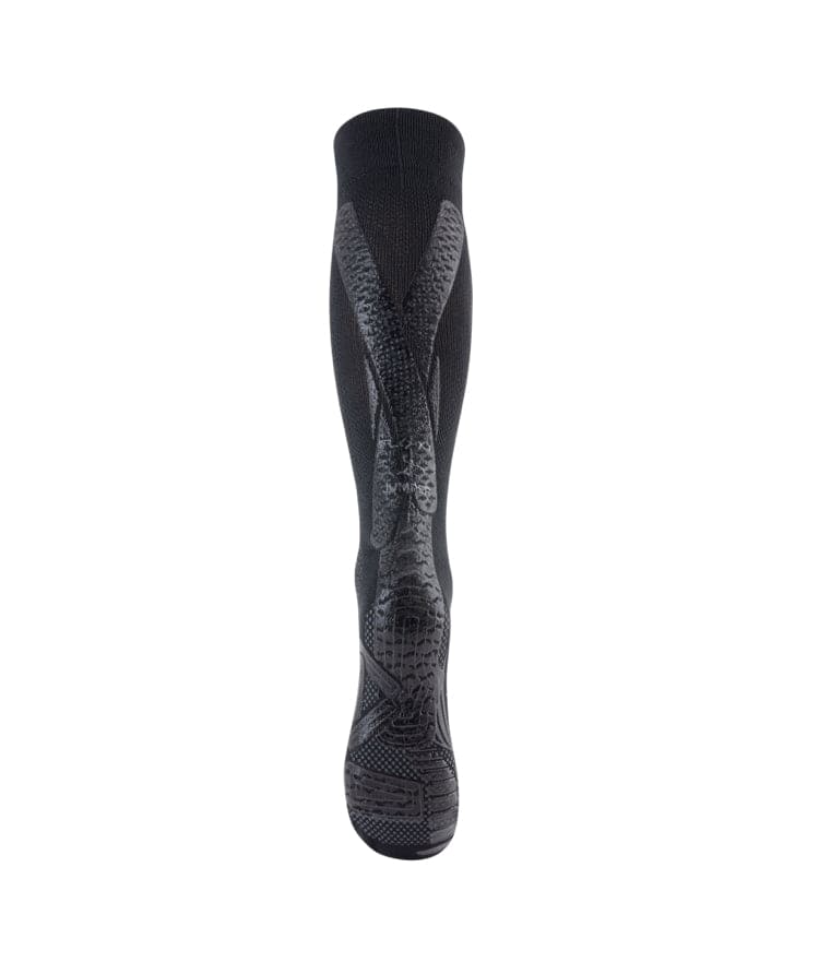 3/4 front view of black Floky Jumper Long over-the-calf compression sock with dark grey anatomical zone mapping and structured compression panels throughout, product shot on white background